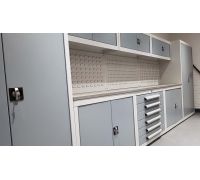 Full rear wall of garage storage cabinets, drawers, worktop and louvre panels with top cabinet system on posts